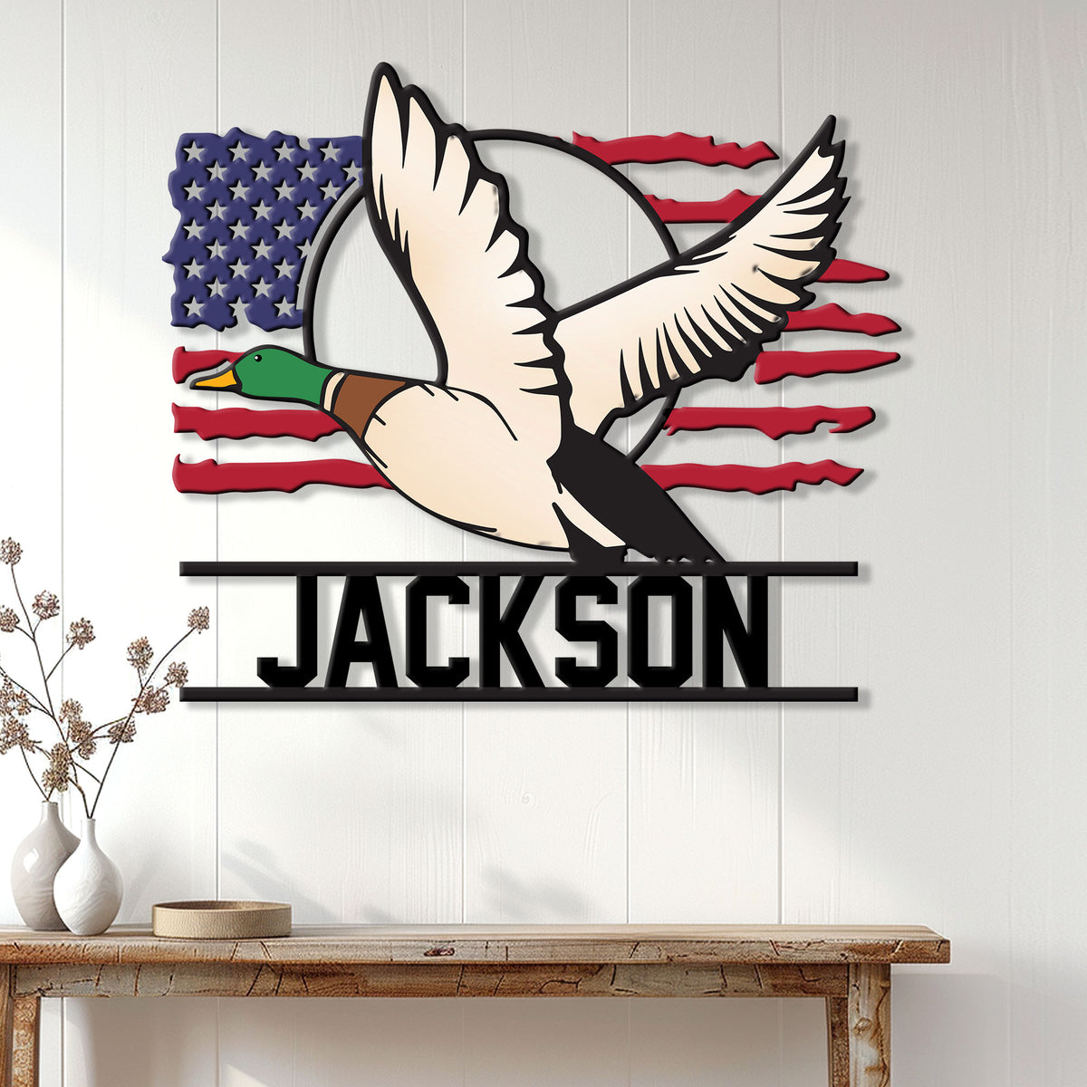 Flying mallard duck hunting wall sign displayed as patriotic decor on a light wood-paneled wall