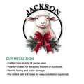 Cut metal sheep sign artwork with a festive bow and evergreen wreath-style holiday accents