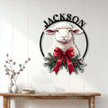 Christmas sheep wall sign displayed on a white paneled wall above a rustic console table