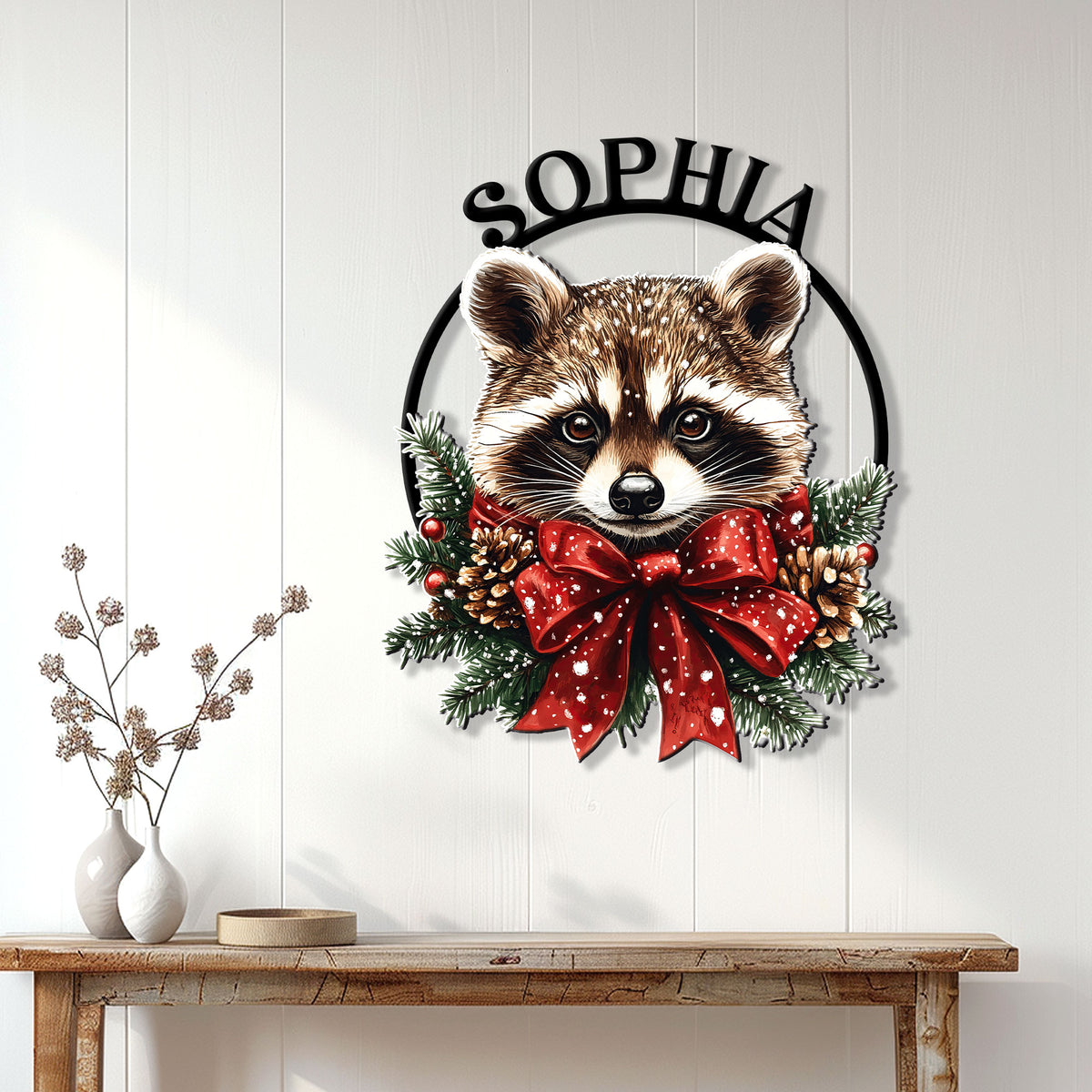 Christmas raccoon wall sign displayed on a light paneled wall above a rustic console table