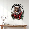 Christmas wolf wall sign displayed on a white paneled wall above a console table