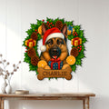 German Shepherd Christmas wall sign displayed on a white paneled wall above a console table