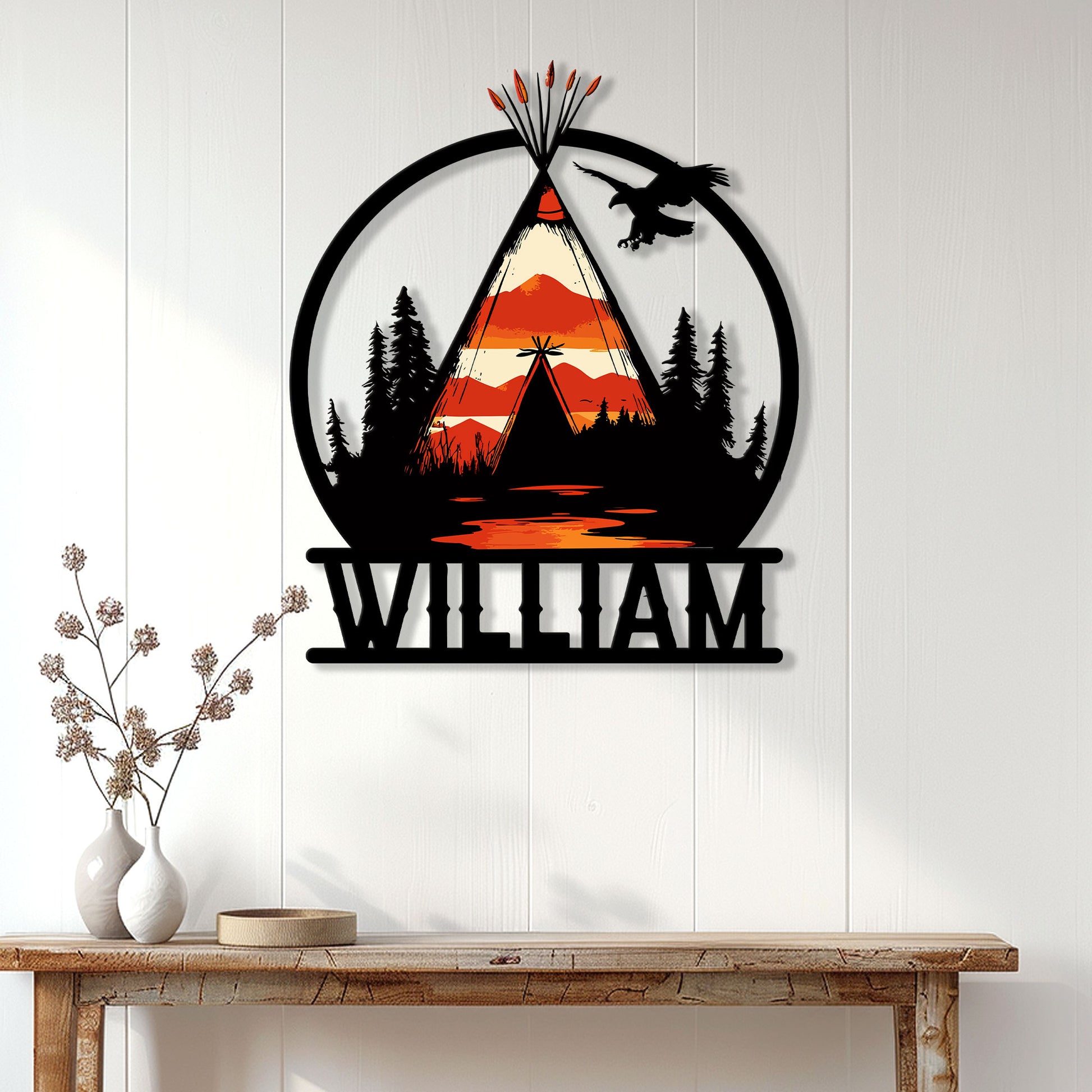 Native American wall decor displayed on a light wood wall, featuring a teepee, eagle, trees, and mountain landscape