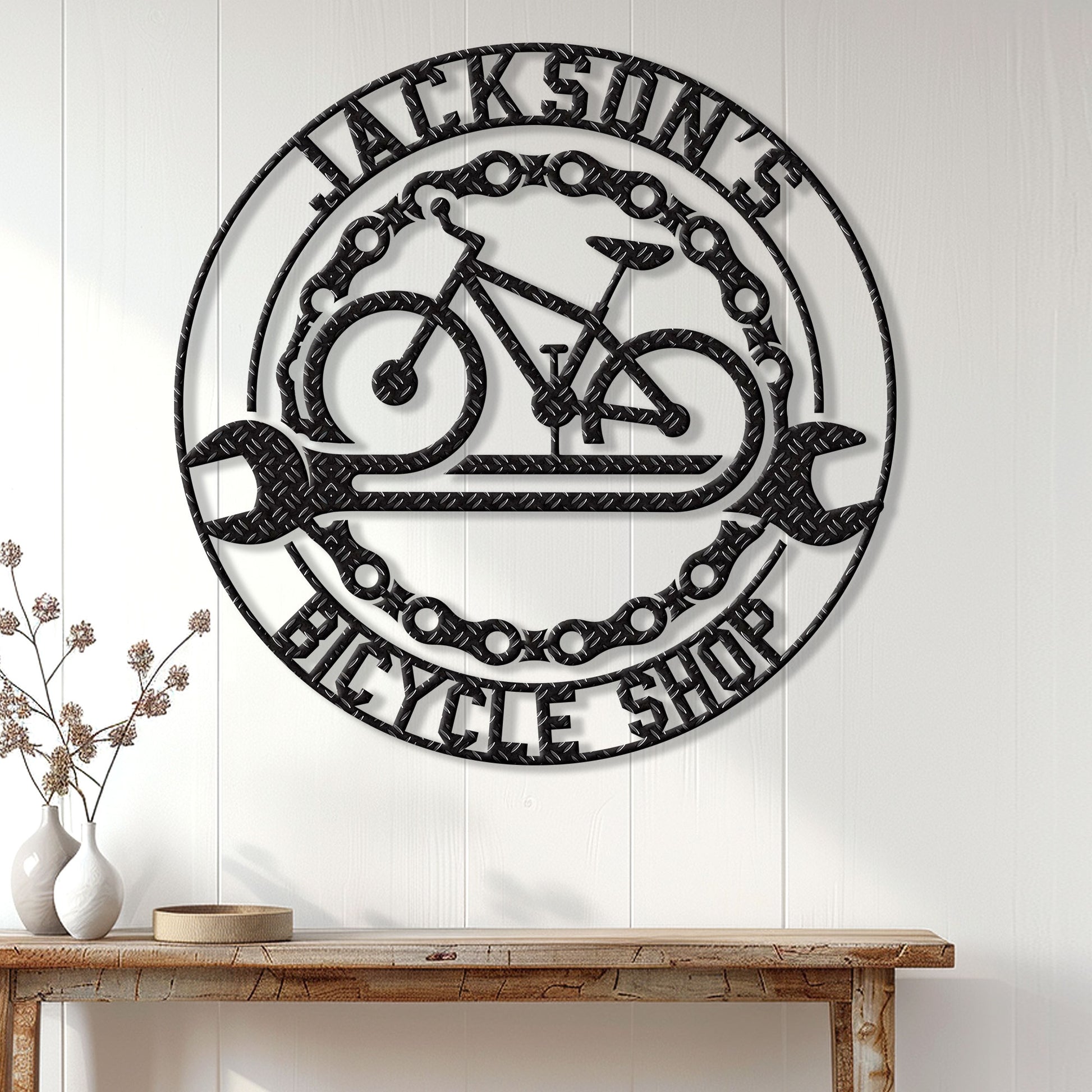Cyclist metal wall sign displayed on a white paneled wall above a rustic console table