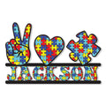 Custom autism metal sign featuring a colorful puzzle-pattern hand, heart, and puzzle piece design