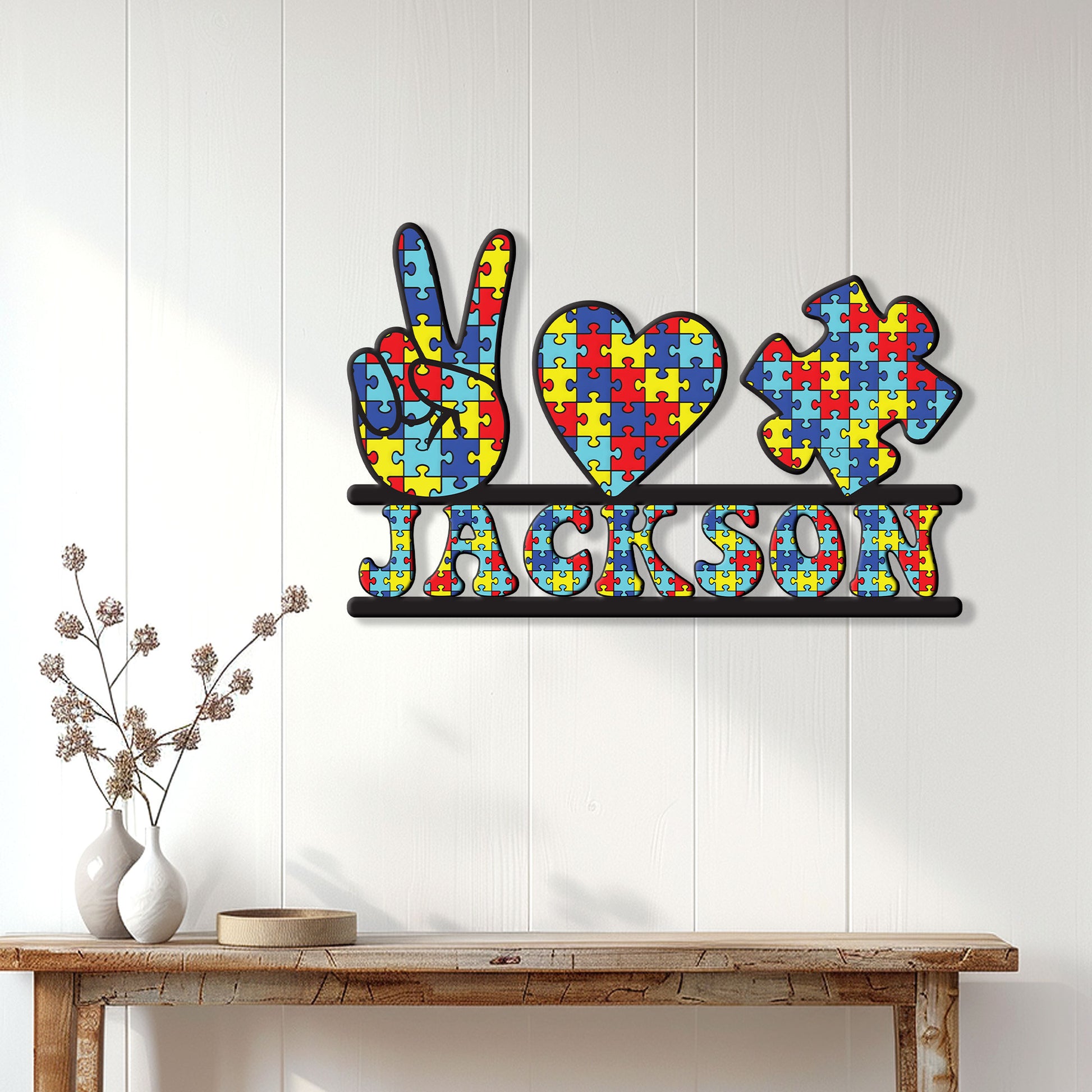 Colorful autism metal wall sign displayed on a bright white paneled wall above a console table
