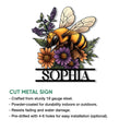Bee and flower metal sign shown with its cut design and decorative garden-inspired artwork