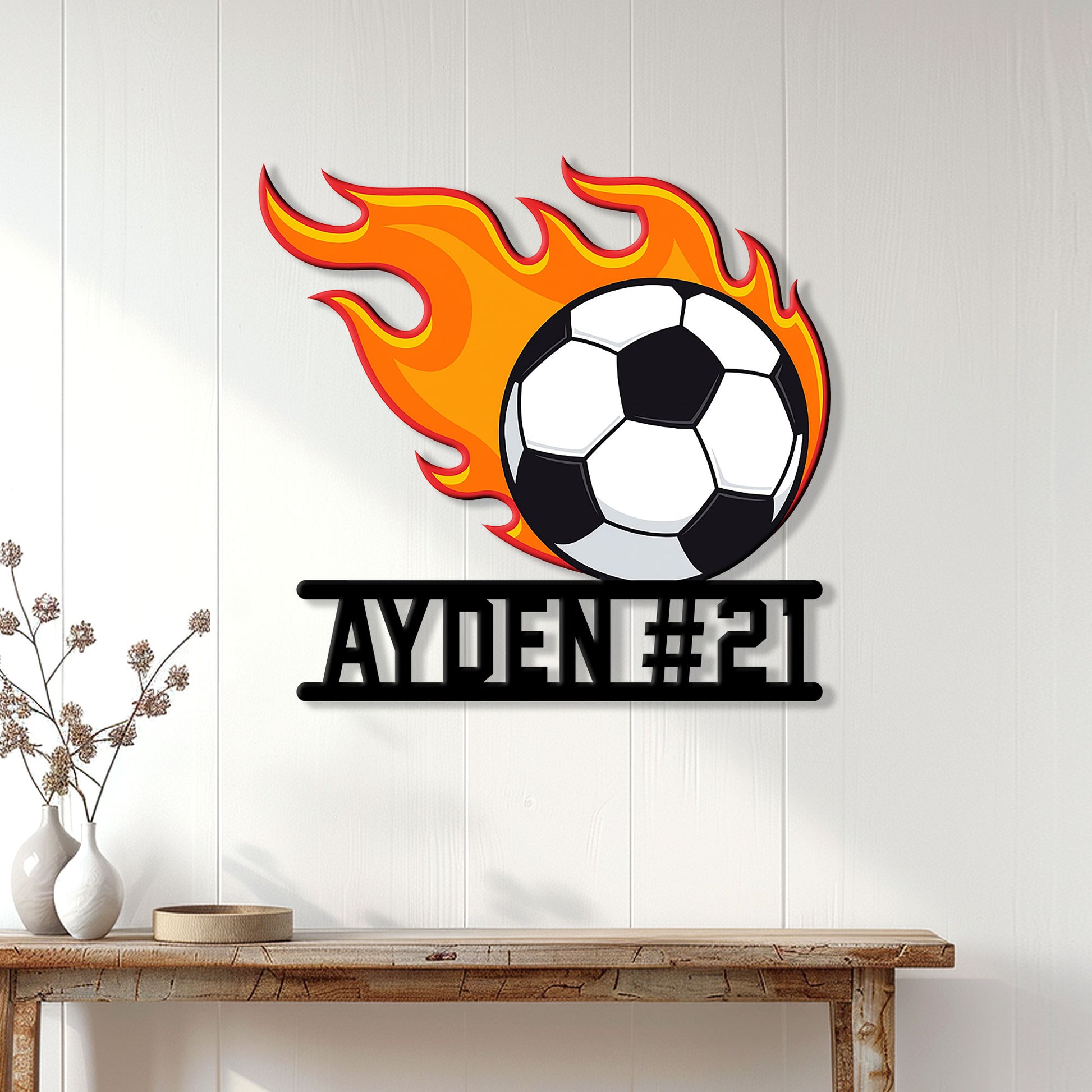 Flaming soccer ball wall sign displayed on a bright paneled wall in a home