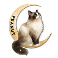 Ragdoll cat metal sign featuring a fluffy blue-eyed cat resting on a sparkling golden crescent moon