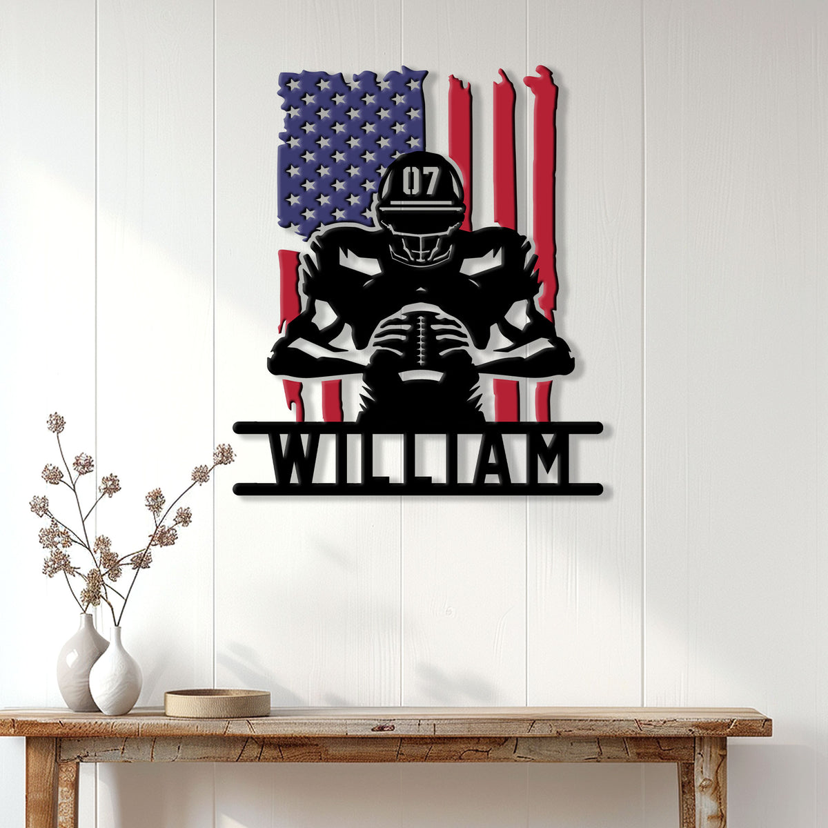 American football metal wall sign displayed on a light wood-paneled wall above a console table