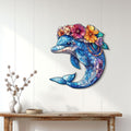Colorful dolphin wall decor displayed on a light wood-paneled wall above a console table