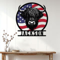Highland cow wall sign displayed on a white paneled wall above a rustic console table
