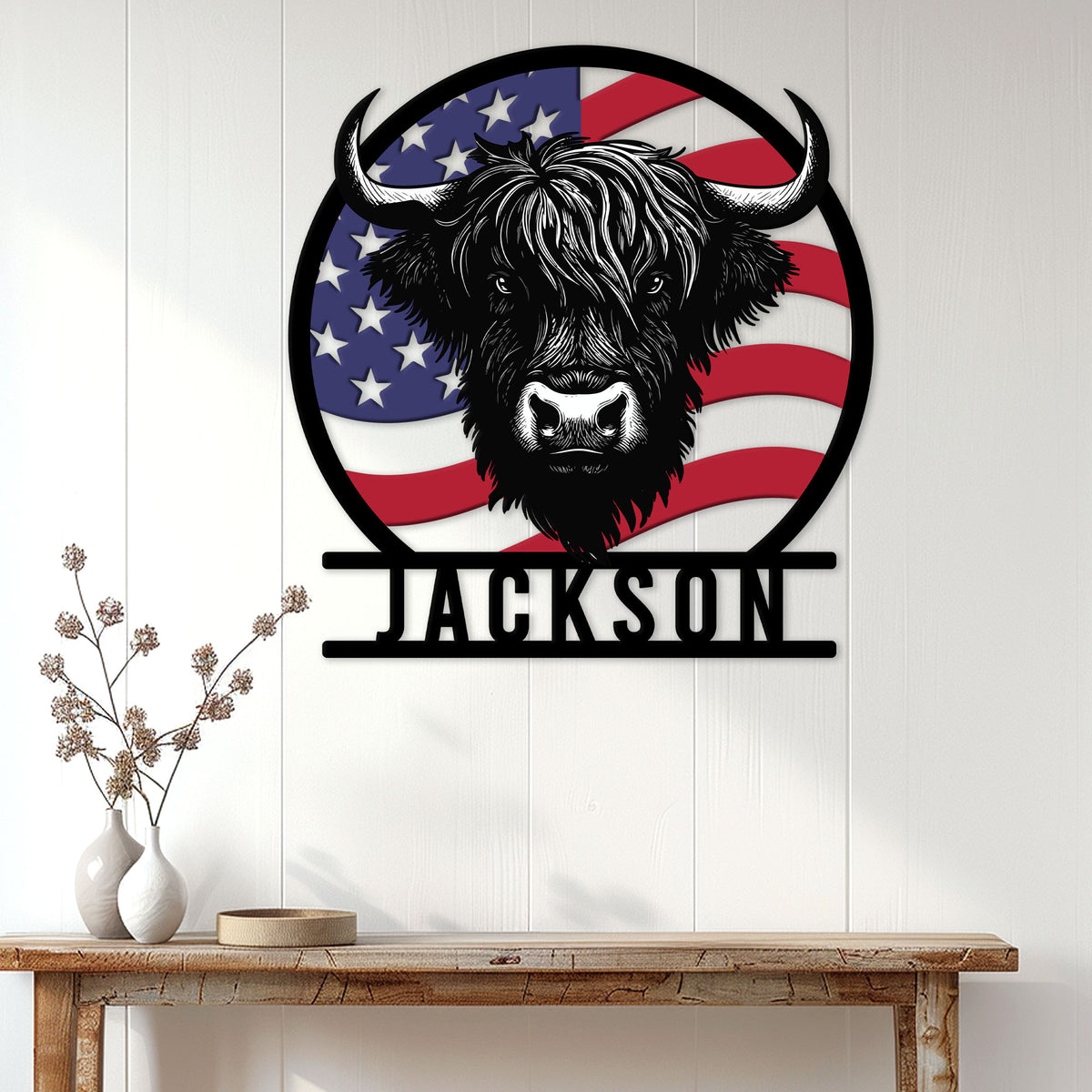 Highland cow wall sign displayed on a white paneled wall above a rustic console table