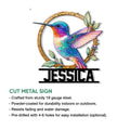 Hummingbird cut metal sign featuring jewel-toned bird artwork and a decorative botanical frame