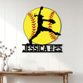 Fastpitch softball wall decor displayed on a light paneled wall above a console table