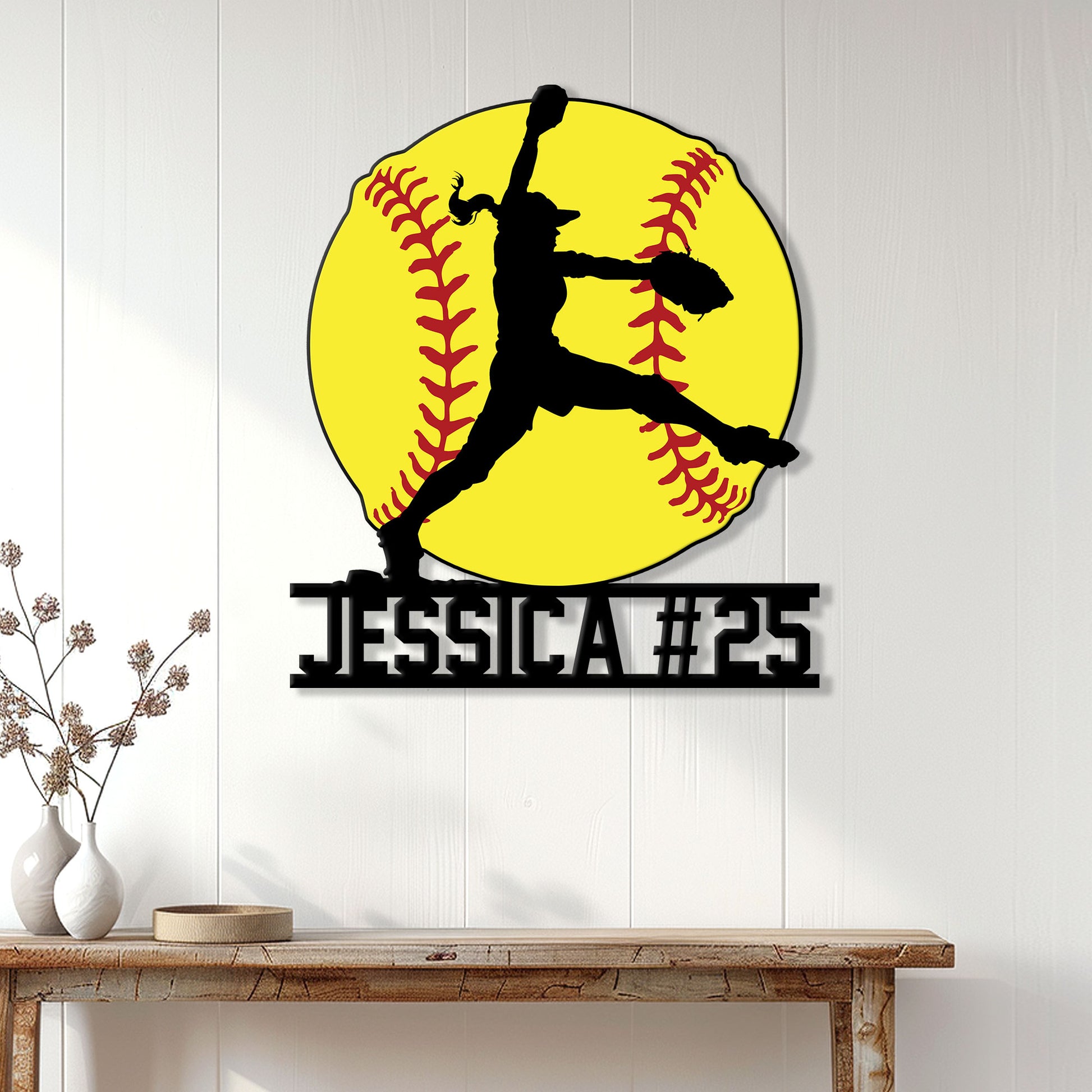 Fastpitch softball wall decor displayed on a light paneled wall above a console table