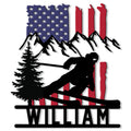 Patriotic skier silhouette metal sign with snowy mountains, pine tree, and American flag design