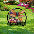 Dragonfly yard sign displayed in a flower garden with colorful blooms and lush green landscaping