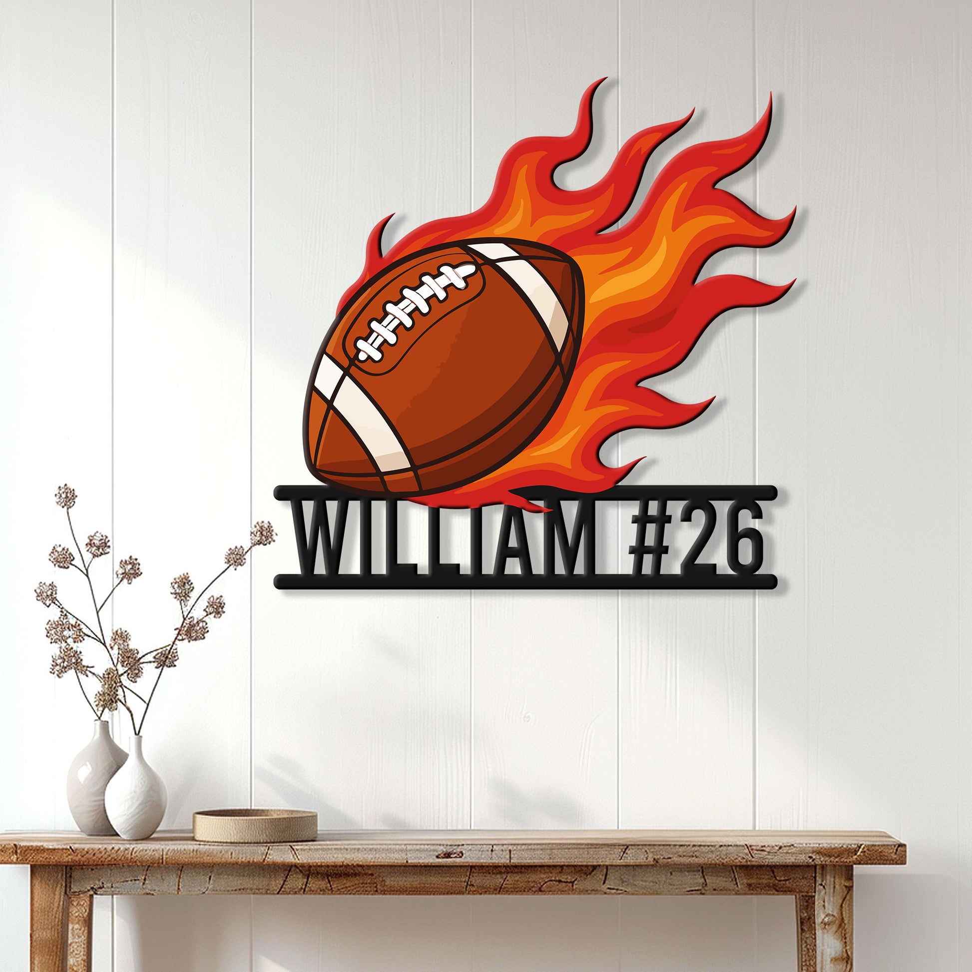 Flaming football metal sign displayed on a light wood-paneled wall above a console table