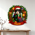 Tuxedo cat Christmas metal sign displayed on a white paneled wall above a console table
