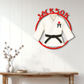 Karate metal wall sign displayed above a console table in a bright modern home interior