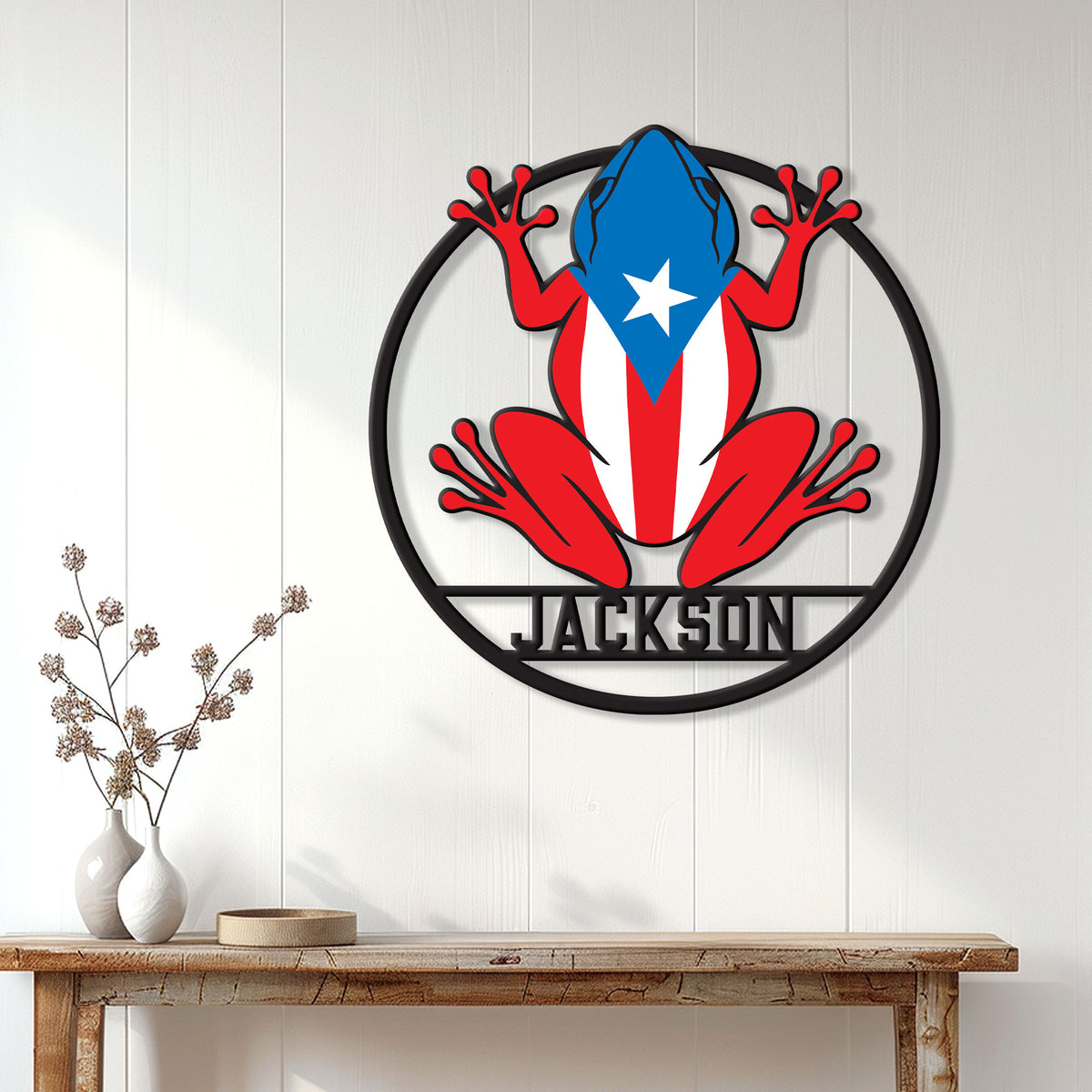 Puerto Rico frog wall sign displayed on a bright white paneled wall above a console table