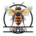 Colorful geometric bee metal sign with outstretched wings framed by a bold circular outline