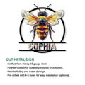 Cut metal bee sign featuring a vibrant faceted insect design and circular wall decor frame