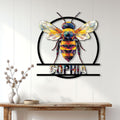 Geometric bee metal wall sign displayed above a console table in a bright home interior