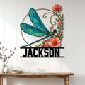 Floral dragonfly wall sign displayed above a console table in a bright modern home