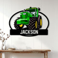 Green farm tractor wall sign displayed on a light wood-paneled wall above a console table
