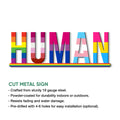 Close-up LGBTQ pride HUMAN metal wall sign with vibrant flag colors and cut metal construction