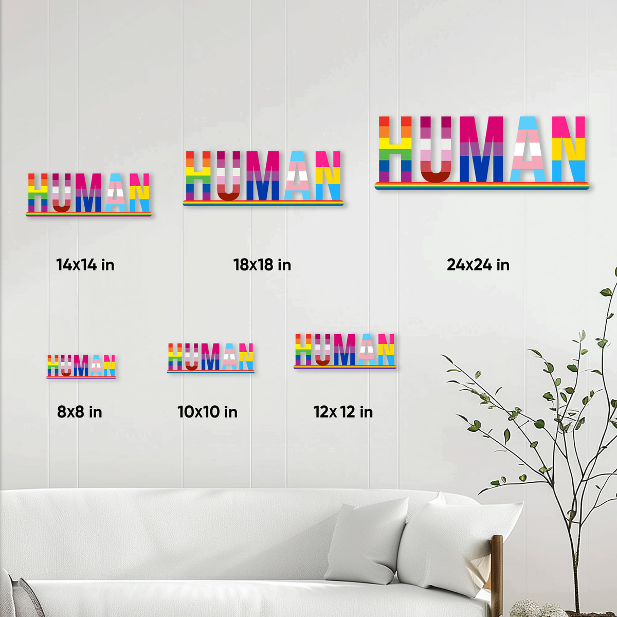 LGBTQ pride HUMAN metal sign shown in multiple sizes on a living room wall