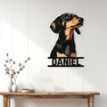 Black and tan Dachshund metal wall sign displayed on a light wood-paneled entryway wall