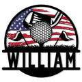 Patriotic golf metal sign featuring a golf ball, club, tees, grass silhouette, and American flag design