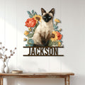 Siamese cat floral metal wall sign displayed on a white paneled entryway wall