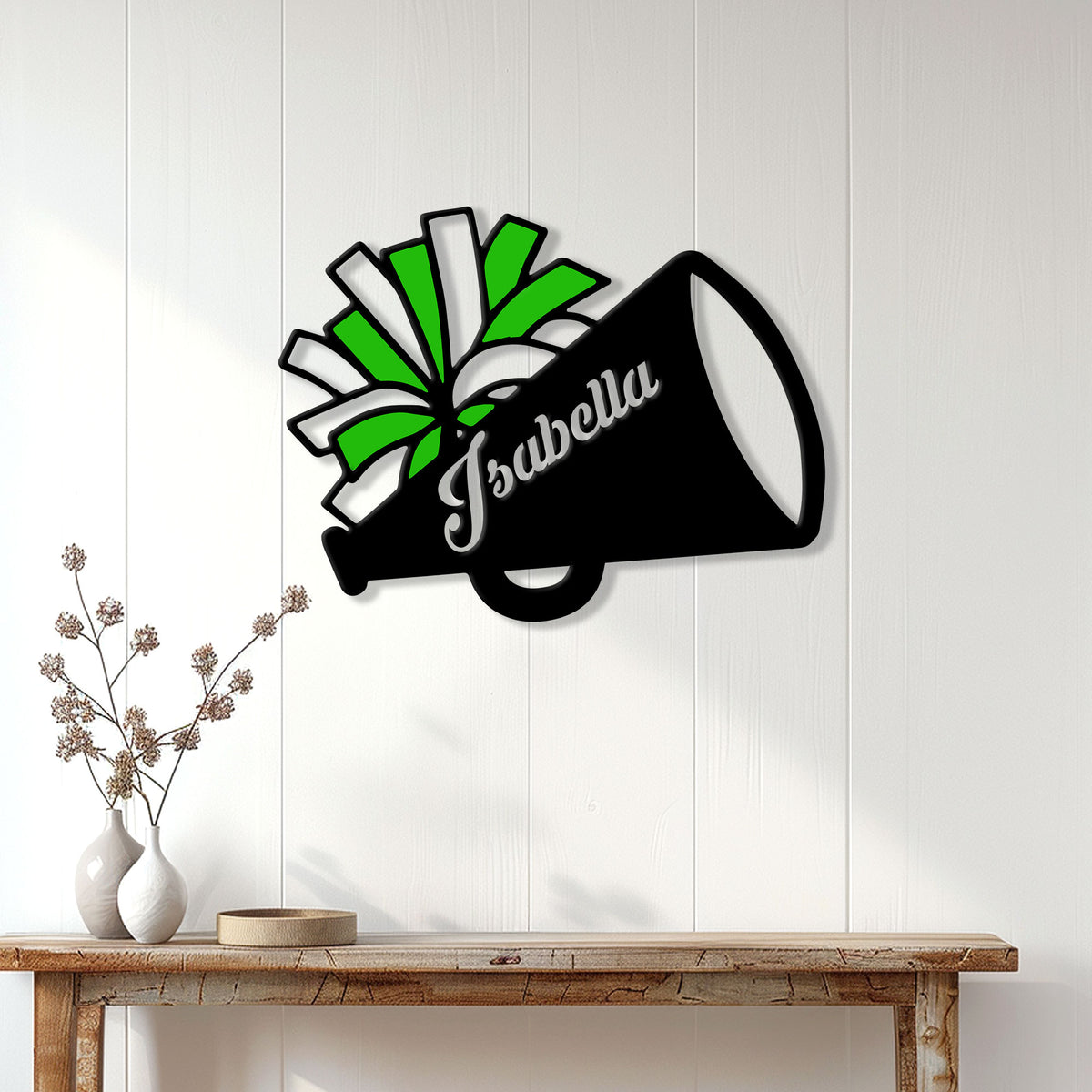 Green and black cheerleading megaphone metal sign styled as wall decor above a console table