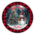 Round Christmas metal sign featuring a snowman, decorated tree, snowflakes, and buffalo plaid border