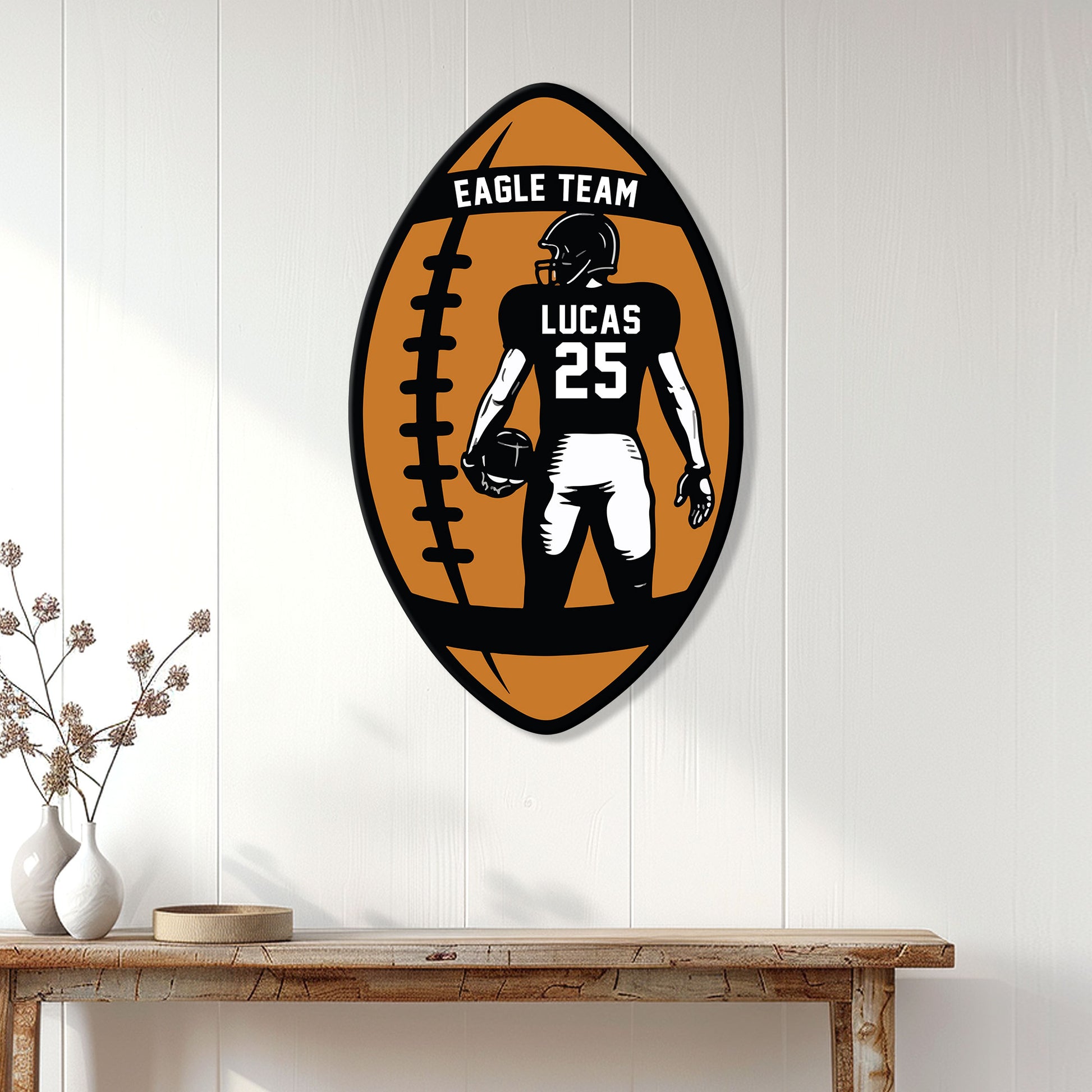 Football metal sign featuring a helmeted player displayed on a white paneled wall above a console table