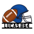 Close-up view of a football helmet and ball design on a custom metal sign