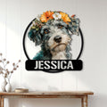 Floral Schnoodle wall sign displayed on a light paneled wall above a console table