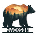 Custom bear-shaped metal sign featuring a forest, mountain, and glowing sunset silhouette