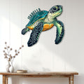 Sea turtle metal wall art displayed on a white paneled wall above a console table