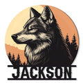 Round wolf metal sign featuring a detailed black and cream wolf portrait against a sunset and pine forest