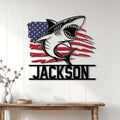 Patriotic shark wall sign displayed on white paneling above a console table