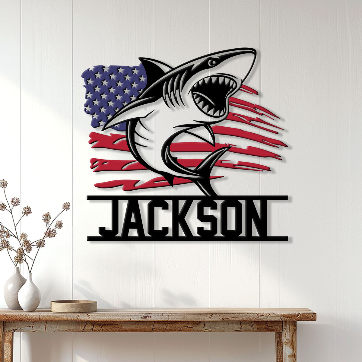 Patriotic shark wall sign displayed on white paneling above a console table