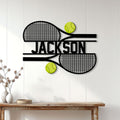 Tennis wall decor displayed above a console table with crossed rackets and bright tennis balls