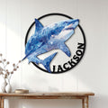 Blue polygonal shark wall sign displayed on a white paneled wall above a console table