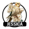Detailed cockatiel metal sign with a graceful bird perched among white blossoms inside a black circular frame