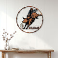 Rodeo bull riding metal sign displayed on a white paneled wall above a rustic console table